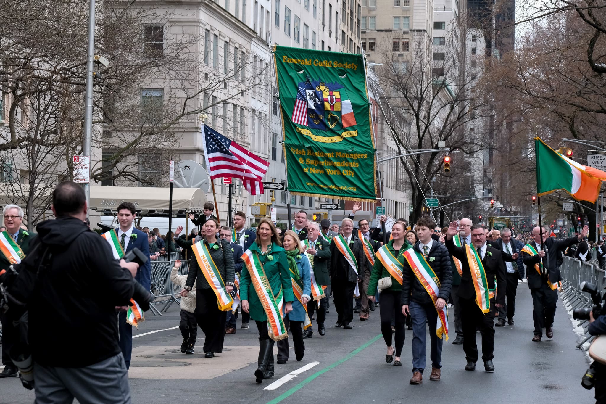 Emerald Guild Society members marching behind the Guild banner during the St. Patrick's Day Parade in New York City.